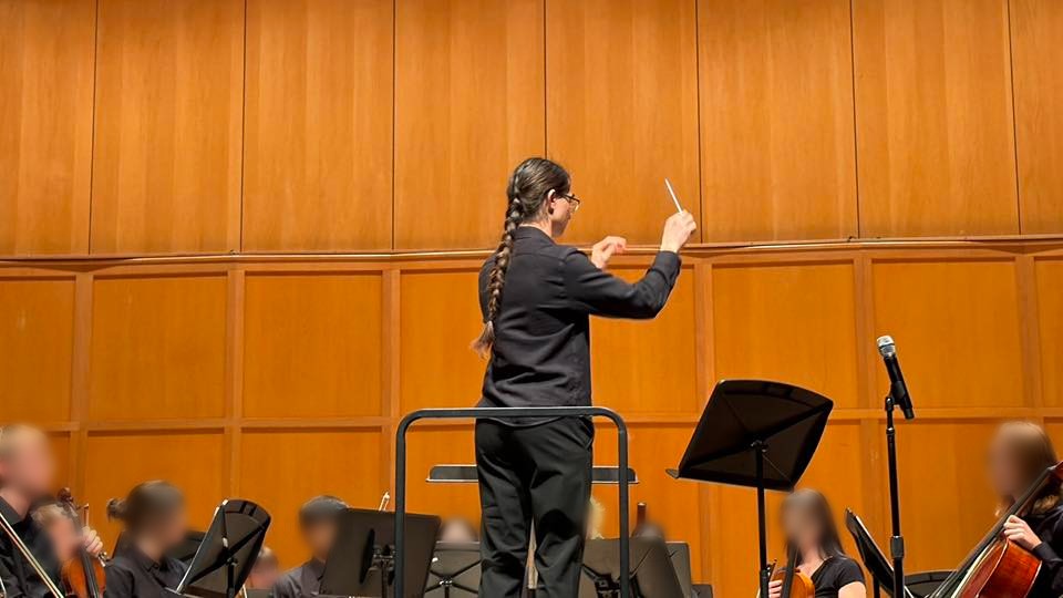 Cameron Bryzek conducting an orchestra